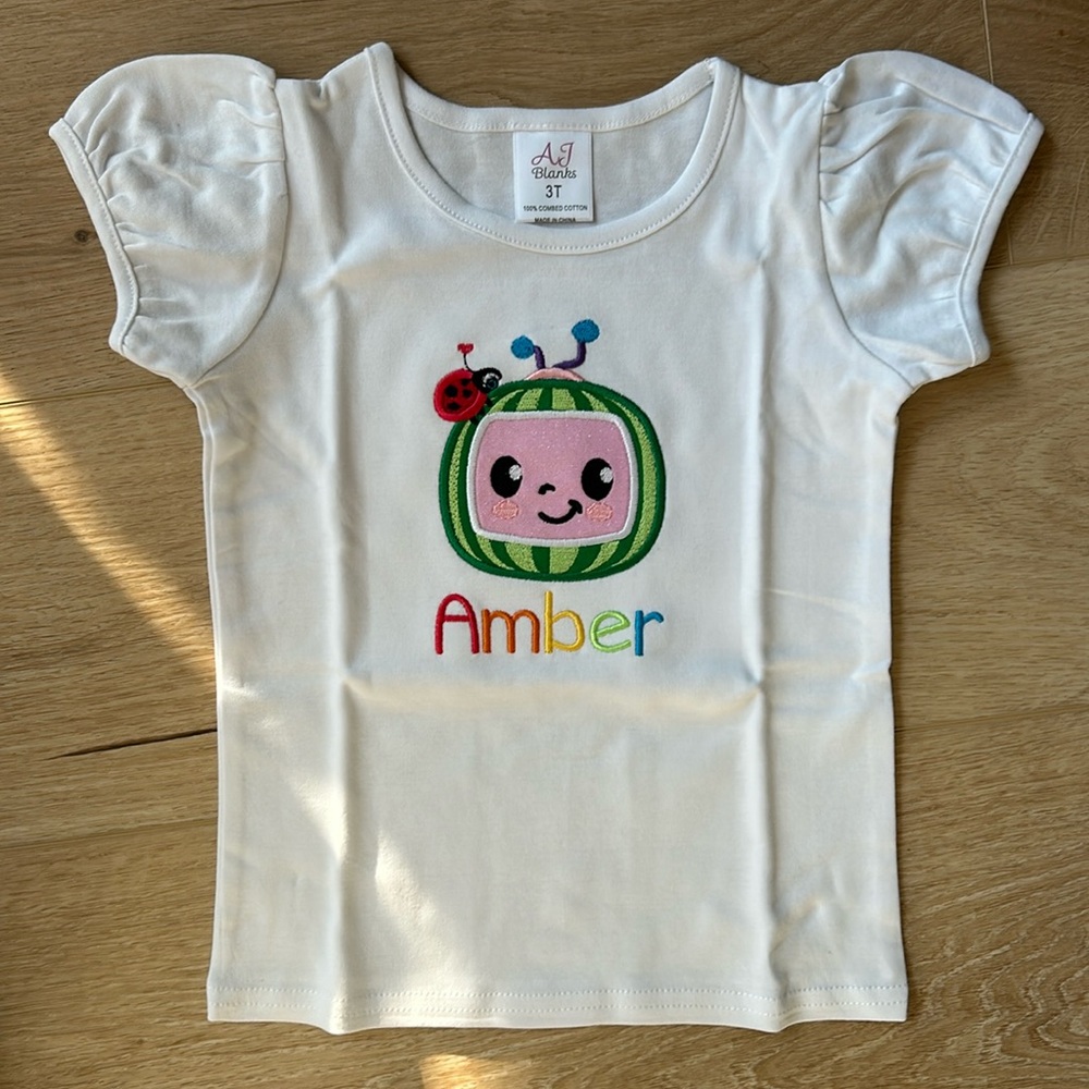 Brand new Cocomelon embroidered girls shirt with the name Amber rainbow letters